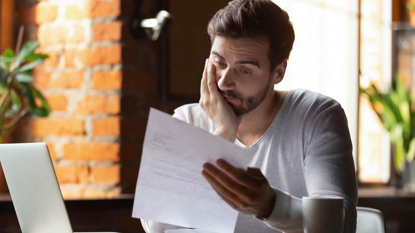Workers With Depression & Mental Health Conditions Can Get Work Accommodations Worker reading over accommodation paperwork and looking stressed.