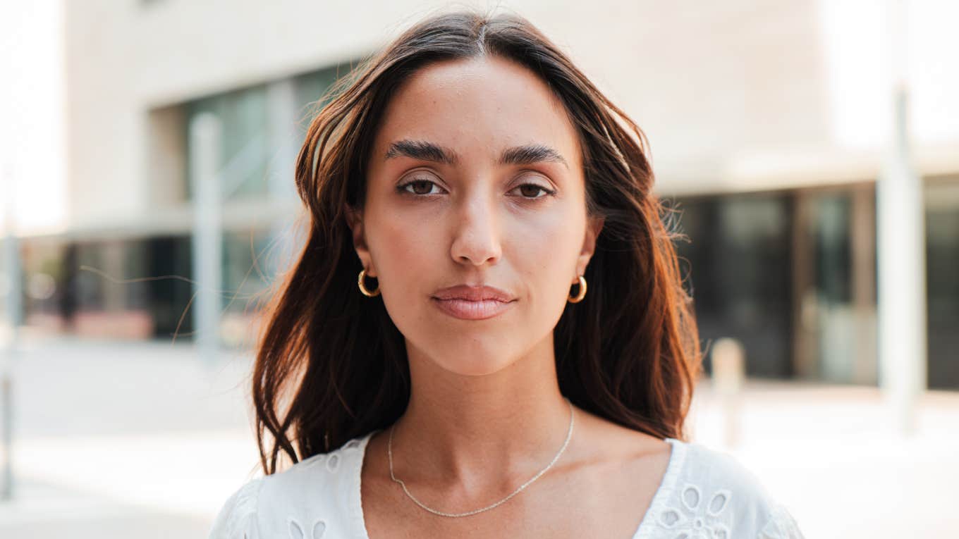 Woman Says Brand Used AI Deepfake Of Her To Promote Their Product portrait of a Hispanic girl with a serious expression looking at camera