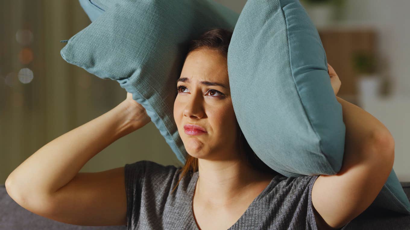 Signs Of A Genuinely Annoying Person, According To Psychology Woman notices the signs that someone is a genuinely annoying person.