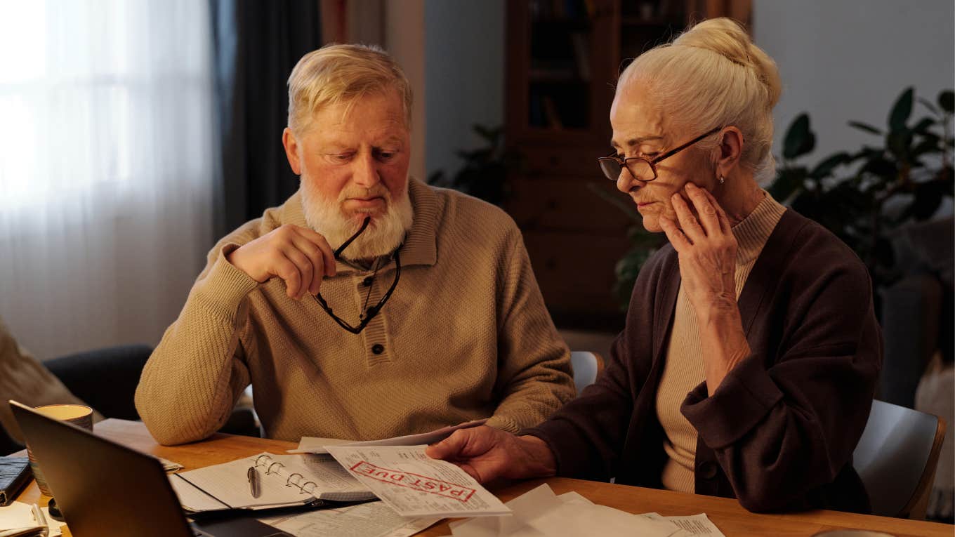 Millennial Says The Boomer Financial Struggle Is Proof That Younger Generations Were Right older couple struggling to pay bills