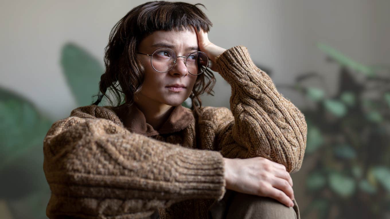 Strange Signals Your Body Sends When You’re Under Too Much Stress Stressed woman holding her head while sitting