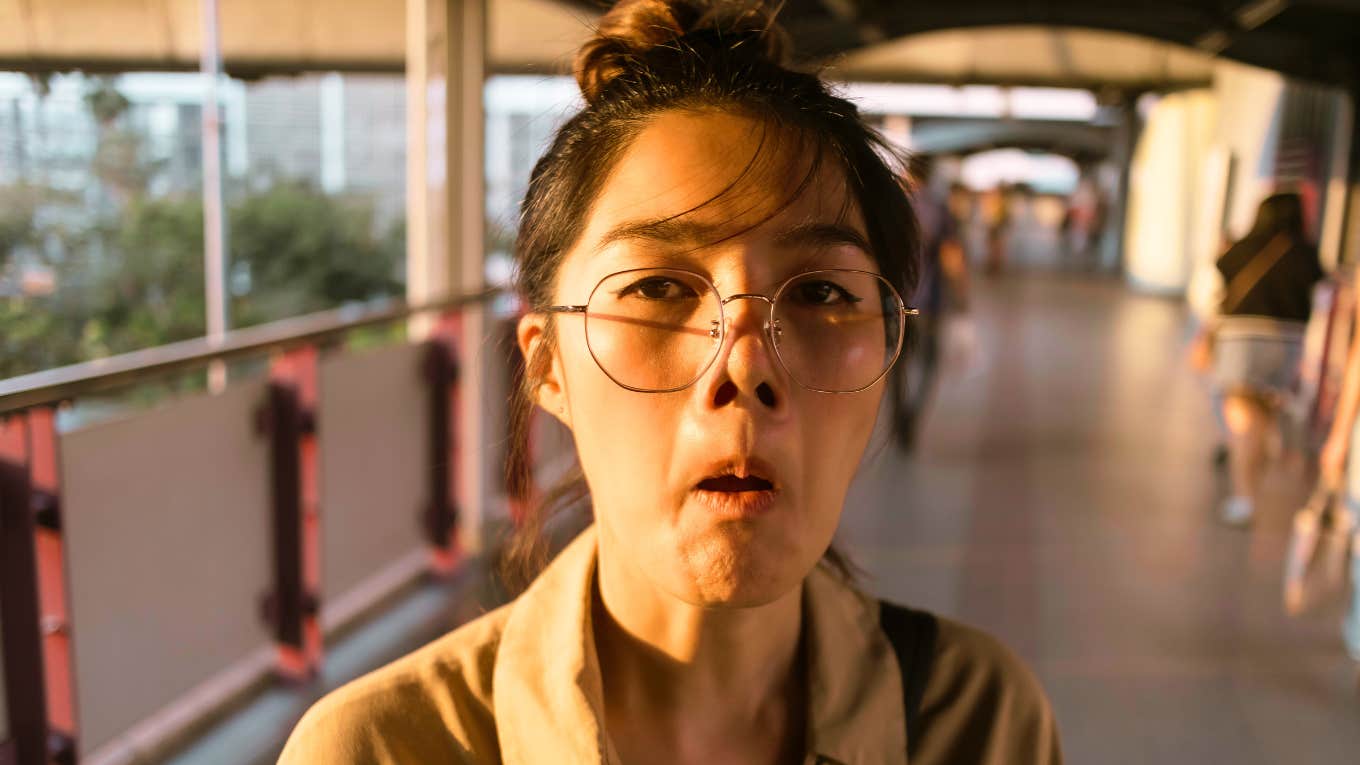 Behaviors People Do Without Realizing That Make Them Seem Low-Value woman making awkward face to the camera