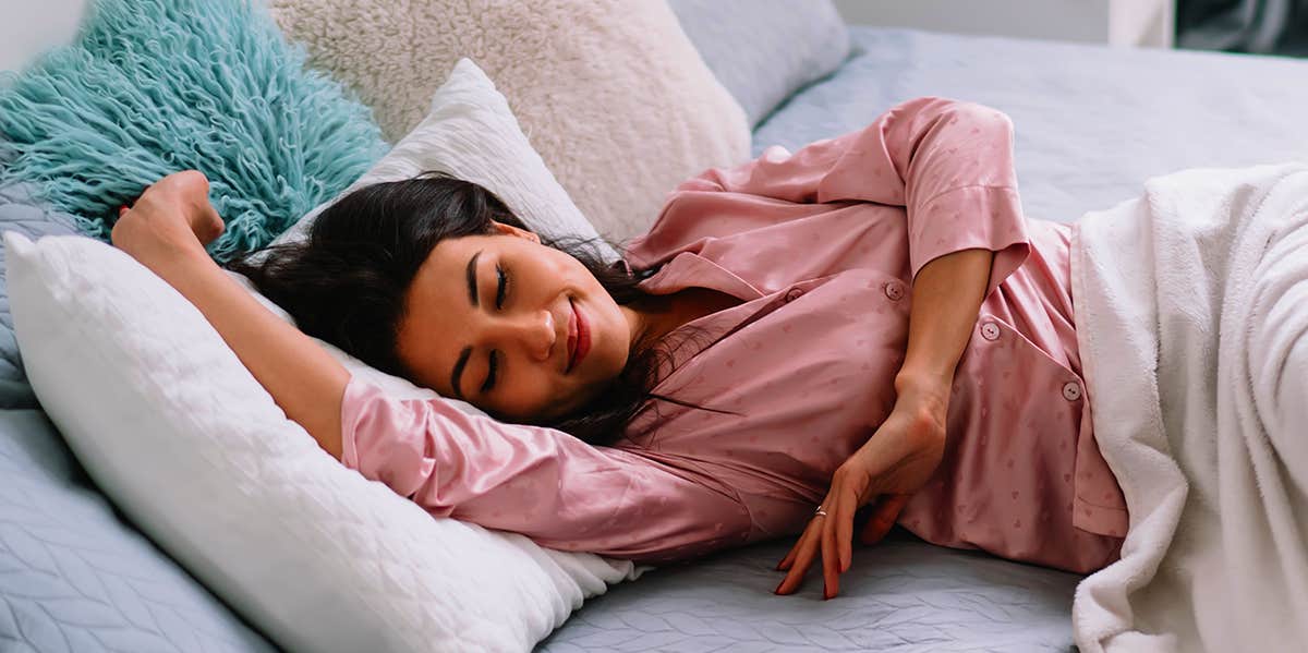 Sleeping In This Position Makes You Get Wrinkles Faster, Says Science woman sleeping in bed