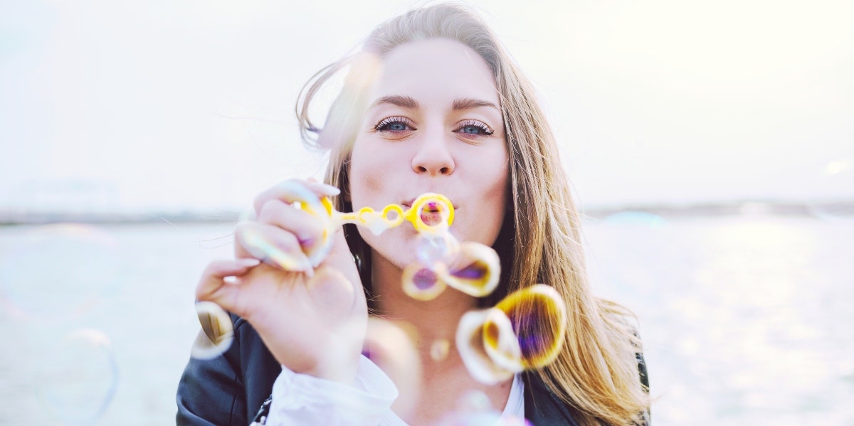 make it to your goals woman blowing bubbles