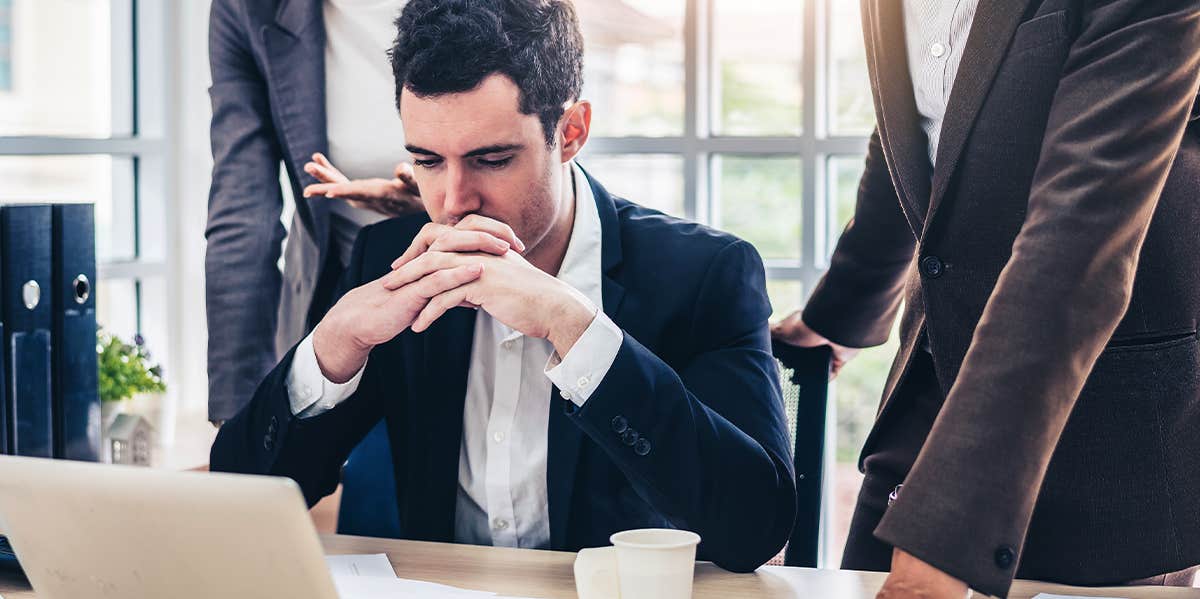 Signs Of A Micromanager Boss & How To Deal With Them man at the computer with boss standing over him