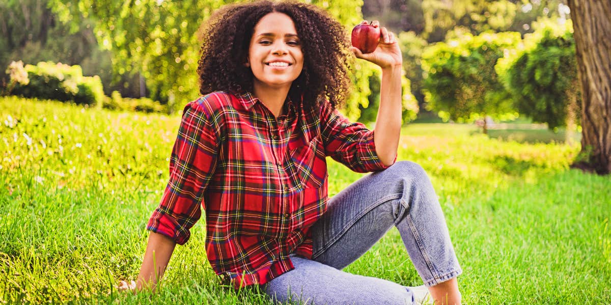 New Habits ADHD Smiling woman holds apple