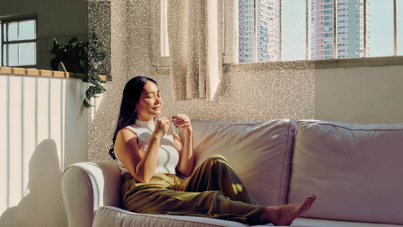The One Mindfulness Technique That Eliminates Anxiety Instantly Woman taking a mindful moment on her couch