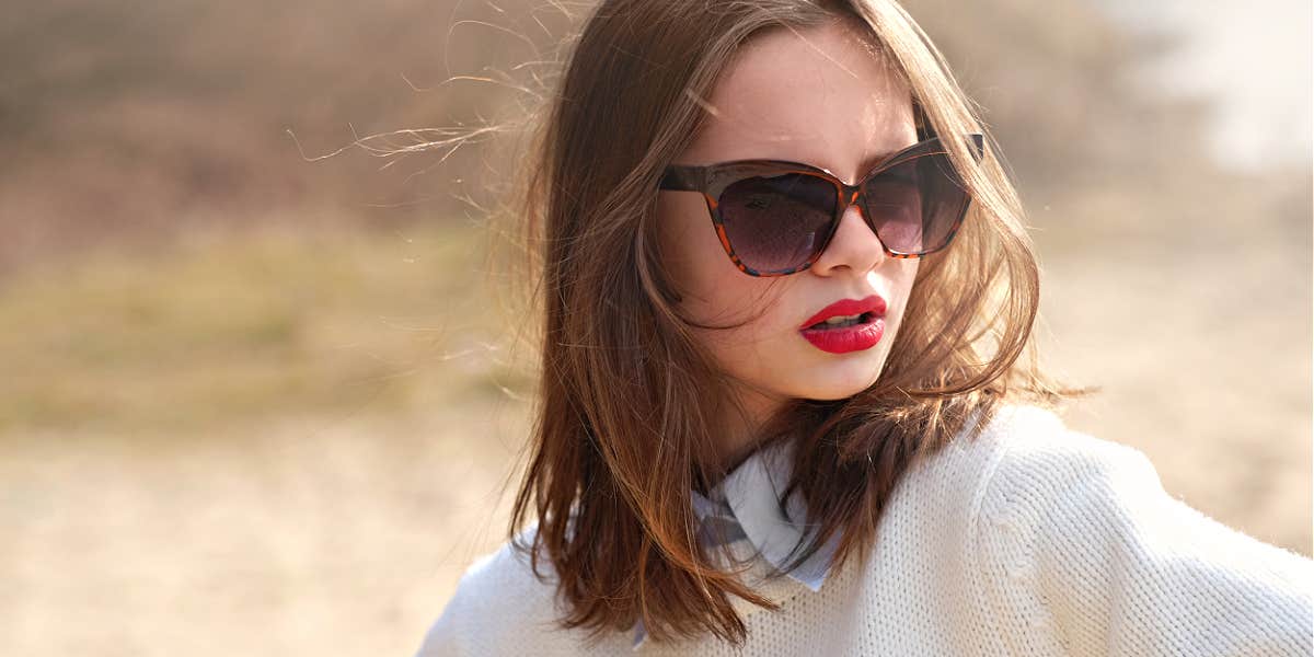Signs your parents never apologized Young brunette with red lips and sunglasses with an attitude