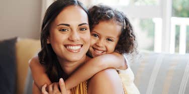 happy mother holding her young daughter