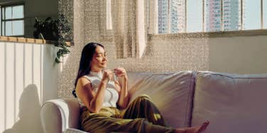 Woman taking a mindful moment on her couch 